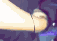a blurred image of a person 's arm with a bracelet on it