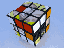 a rubik 's cube has a picture of a girl and the letter m on it