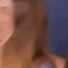 a close up of a woman 's face with a blurry background
