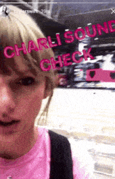 a woman in a pink shirt with charlisound check written on her face