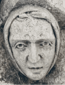 a statue of a woman 's face with a hood on