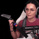 a woman wearing headphones is holding a guitar with the word gibson on it