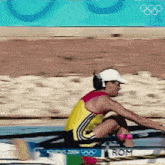 a man in a white hat is rowing a boat with the word rom on the side