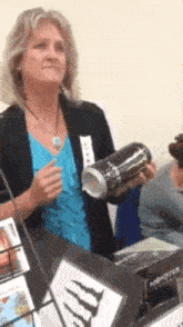 a woman holding a can of monster energy drink