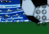 a soccer game is being played on a phone with a soccer ball in the foreground