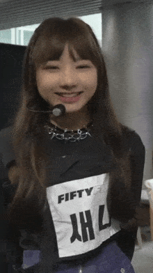 a girl wearing a shirt that says fifty fifty on it