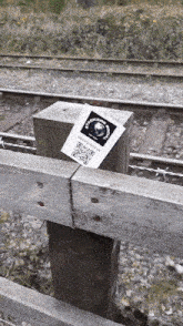 a wooden post with a sticker on it that says ' fisherman central '