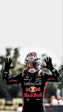 a man wearing a helmet and a red bull shirt