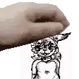 a close up of a hand holding a drawing of a rabbit .