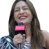 a woman is smiling while holding a microphone that says pinkvilla