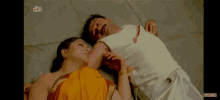 a man and a woman are laying on the floor and the screen says ullu on it