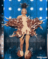 a drag queen is wearing a giraffe costume and slippers .