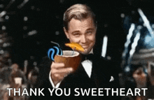 a man in a tuxedo is holding a coconut drink with a straw and says `` thank you sweetheart '' .