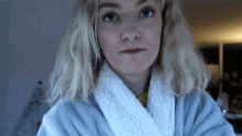 a woman wearing a white robe with a sherpa collar