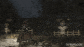 a gif from gifrun.com shows a man holding a sword in a field