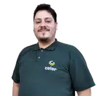 a man with a beard wears a green celer polo shirt