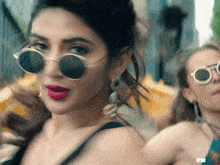 a close up of a woman wearing sunglasses and a fn logo in the corner