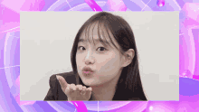 a girl blowing a kiss with a ring in her hand