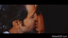 a man and a woman are kissing each other on a black background .