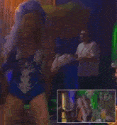 a woman in a blue and white costume is dancing