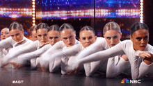 a group of female dancers on a stage with the nbc logo