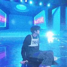 a person wearing a shirt with the letters thi-0 on it