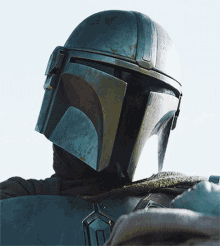 a close up of a person wearing a helmet with a badge on it