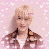 a young man is making a heart shape with his hands .