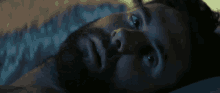 a man with a beard is laying on a bed