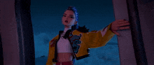 a woman in a yellow jacket with a dragon on it is standing in a doorway