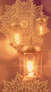 a lantern with a candle inside of it and a mandala behind it
