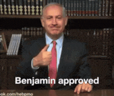 a man in a suit and tie is giving a thumbs up and the words benjamin approved behind him