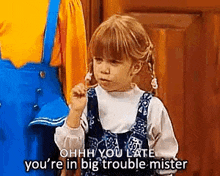 a little girl from full house is talking on a cell phone .