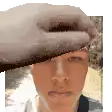 a pixelated image of a man 's face with a hand covering his face .