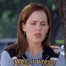a woman says well it bites while making a funny face