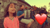 a man playing an accordion next to a girl and a heart