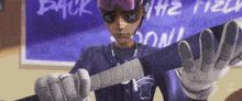 a man in a purple baseball uniform is holding a baseball bat in his hands .