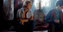 a man and a woman are sitting on the floor in a room .