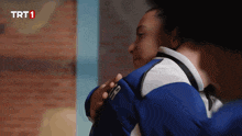 two people hugging with trt1 written on the bottom left