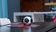 a toy that looks like a camera is on a desk