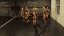 a group of women are dancing in front of fraules dance centre