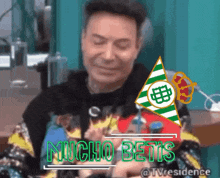 a man with a green and white triangle with the word mucho betis on it