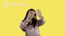 a woman is standing in front of a yellow background with the words `` good morning '' on it .