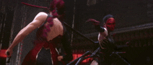 a woman doing a handstand on a stage with a spider behind her