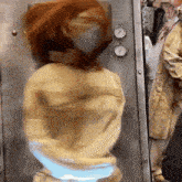 a blurred image of a woman in a yellow jacket