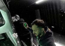 a man in a black hoodie with the letter l on the front