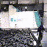 a blurry picture of a person standing in front of a sign that says ' e. ' on it