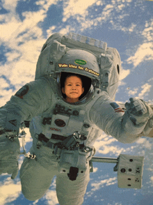 a nasa astronaut with a child 's face in his helmet