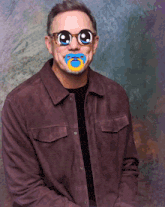 a man with a pacifier in his mouth and sunglasses on