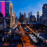 an aerial view of a city at night with the words sanda media on the bottom